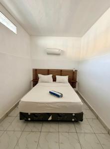 a bedroom with a bed with a book on it at Solara Gili Air in Gili Islands