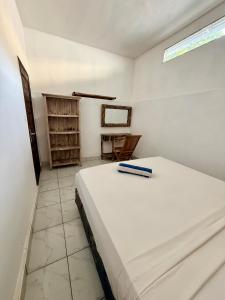 a bedroom with a large white bed in a room at Solara Gili Air in Gili Islands
