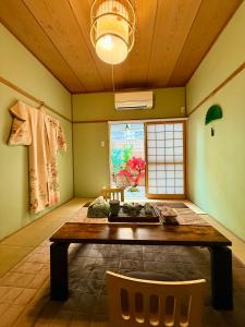 a dining room with a table and a window at Pine Leaf lnn 楓の宿 2号館 in Osaka