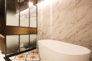 a bathroom with a white tub and a sink at Hotel Avant in Cheonan +76 photos
