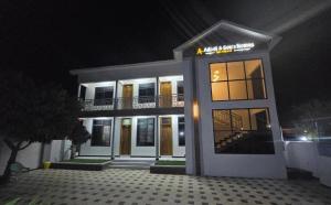 a white building with a balcony at night at Abdel & sons homes in Dodoma