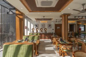 a restaurant with wooden tables and chairs at Perfectstayz Luxe kapilaz - Jacuzzi rooms in Bhowāli