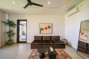 a living room with a couch and a table at Didi Apartment Seseh in Munggu +15 photos