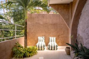 two vases sitting on a patio with plants at Didi Apartment Seseh in Munggu
