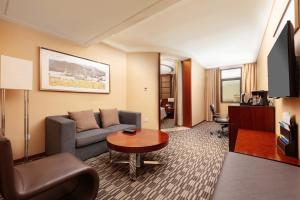 a living room with a couch and a table at Four Points by Sheraton Taicang in Taicang