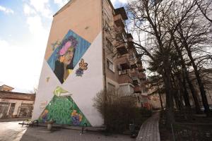 a building with a painting on the side of it at M&S Central Residence in Bitola