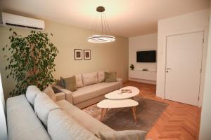a living room with a couch and a table at M&S Central Residence in Bitola