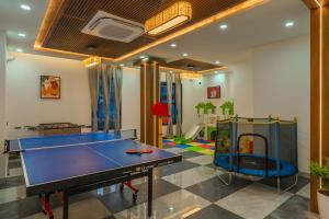 a room with a ping pong table and a play room at Perfectstayz Luxe kapilaz - Jacuzzi rooms in Bhowāli