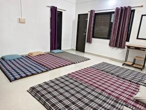 two large carpets on the floor in a room at Durga Bhakt Niwas in Tuljapur