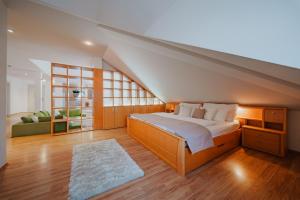 a bedroom with a large bed and a couch at Hotel Ontario in Karlovy Vary