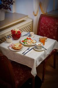 a table with plates of food on top of it at Hotel Ontario in Karlovy Vary