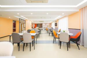 a dining room with tables and chairs at Ibis Shanghai Xujiahui in Shanghai