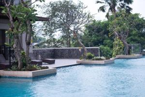 a swimming pool with trees in a house at Trivana Pool View 3BR Senayan in Jakarta