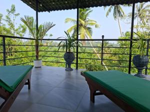 a balcony with potted plants and a view at Fair view in Induruwa