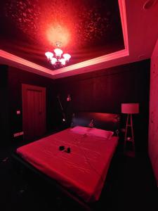a red room with a bed with a red ceiling at The Secret Escape in Bahādurgarh +5 photos