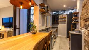 a kitchen with a wooden counter top in a room at Blue Bay Studio Apartment in Wilderness