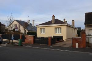 a yellow house with a black fence in front of it at Accueil Porte-Dunoise in Orléans