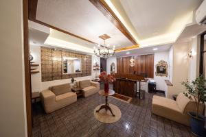 a living room with a couch and a table at Casa Le Damuz At MRT Bangphlat - Adult Only in Bangkok