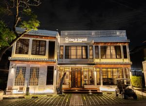 a building with a car parked in front of it at Casa Le Damuz At MRT Bangphlat - Adult Only in Bangkok