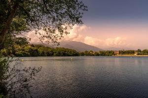 a view of a lake with mountains in the background at ZEcamping 3 étoiles animaux acceptés en bord de lac in Vinça