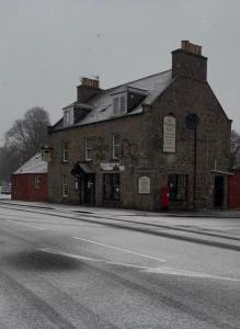 an old brick building on the side of a street at The Staging Post in Aberdeen