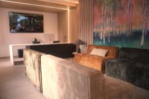 a living room with two chairs and a couch at ND Hoteles in Valdemoro