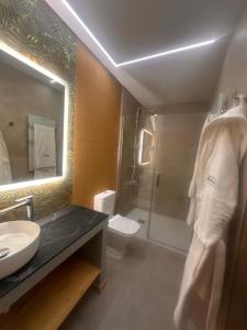 a bathroom with a shower and a sink and a toilet at ND Hoteles in Valdemoro