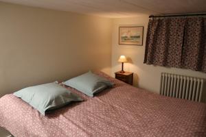 a bedroom with a bed with two pillows on it at Accueil Porte-Dunoise in Orléans