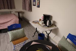 a room with a table with a coffee maker on it at Accueil Porte-Dunoise in Orléans