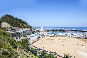 a view of a beach with boats in the water at ATeRIAN GAZTETAPE II in Getaria