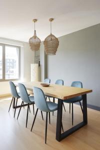 a dining room with a wooden table and chairs at ATeRIAN GAZTETAPE II in Getaria