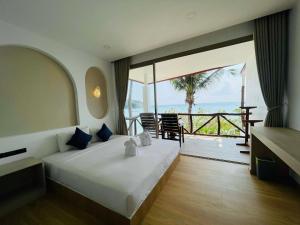 a bedroom with a bed with a view of the ocean at Big Fish Resort Koh Tao in Ko Tao