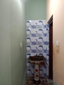 a bathroom with a sink and a wall at Green Valley Homestay in Barkot +27 photos