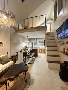 a living room with a staircase and a dining room at Le mar villa in Ko Samed