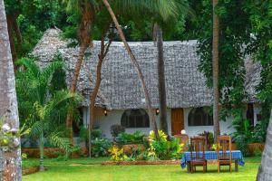 a house with a table and chairs in front of it at Horizon Bavaria Villa in Mtwapa
