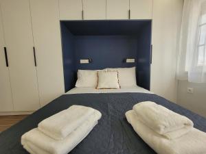 a bedroom with a bed with two pillows on it at Hyacinthus city apartment in Rhodes Town