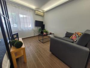 a living room with a couch and a table at Hyacinthus city apartment in Rhodes Town