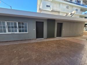 a house with two doors and a building at Hyacinthus city apartment in Rhodes Town