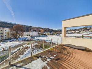 a balcony with a view of a city at LakeSide Suite in Seeboden