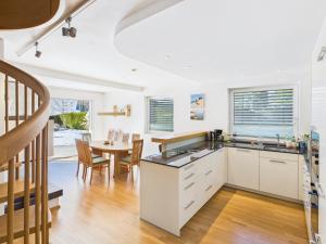 a kitchen and dining room with a table and chairs at LakeSide Suite in Seeboden