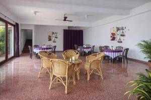 a dining room with purple tables and chairs at Premier Stay in Chavakachcheri