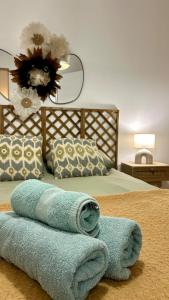 a bedroom with a bed with towels on it at Casa Alba in Saint-Chamond