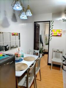 a kitchen and dining room with a table and chairs at Casita Bonita in Marilao +7 photos