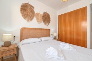 a bedroom with a bed with two towels on it at Apartment Happy Coast Moraira in Moraira