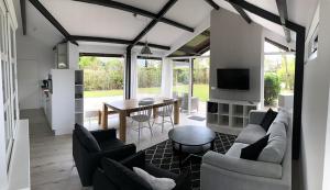 a living room with a couch and chairs and a table at Spacious 6p vacation home with garden in Zoutelande