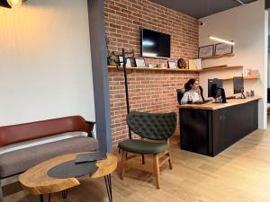 a woman sitting at a desk in a room at Shkodra Hostel & Day Tours in Shkodër