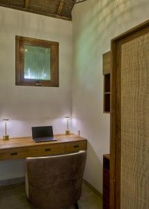 a office with a desk with a laptop computer on it at ARYA Sumba - Kodi Resort in Tambolaka
