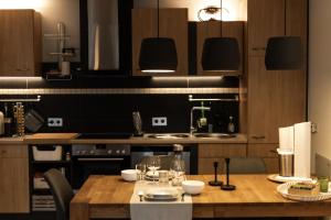 a kitchen with a wooden table with glasses on it at Hohenlupfenblick in Stühlingen