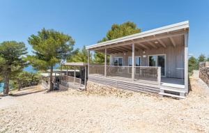 a house with a porch on a beach at Mobile home Clara in Drage