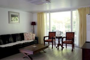 a living room with a couch and chairs and a table at 대전 SJ Haus in Daejeon